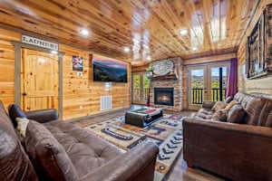 Cozy movie theater room with two sofa beds, a large TV, and a warm fireplace. Perfect for family movie nights or relaxing after a day of exploring. Enjoy ultimate comfort with beautiful views right from your seat!