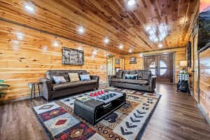 Cozy movie theater room with two sofa beds, a large TV, and a warm fireplace. Perfect for family movie nights or relaxing after a day of exploring. Enjoy ultimate comfort with beautiful views right from your seat!