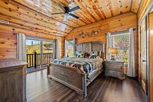 Unwind in this cozy king-size bedroom with a dresser, TV, closet, and private full bathroom. Step onto the balcony with seating to enjoy peaceful nature views. Designed for comfort and relaxation, this rustic retreat is perfect for a restful stay!